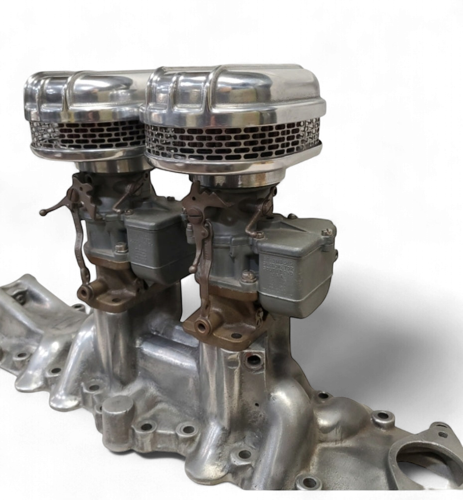 Pair of Stromberg 97 air cleaners installed on dual-carb intake manifold showing polished finned housings and carburetors