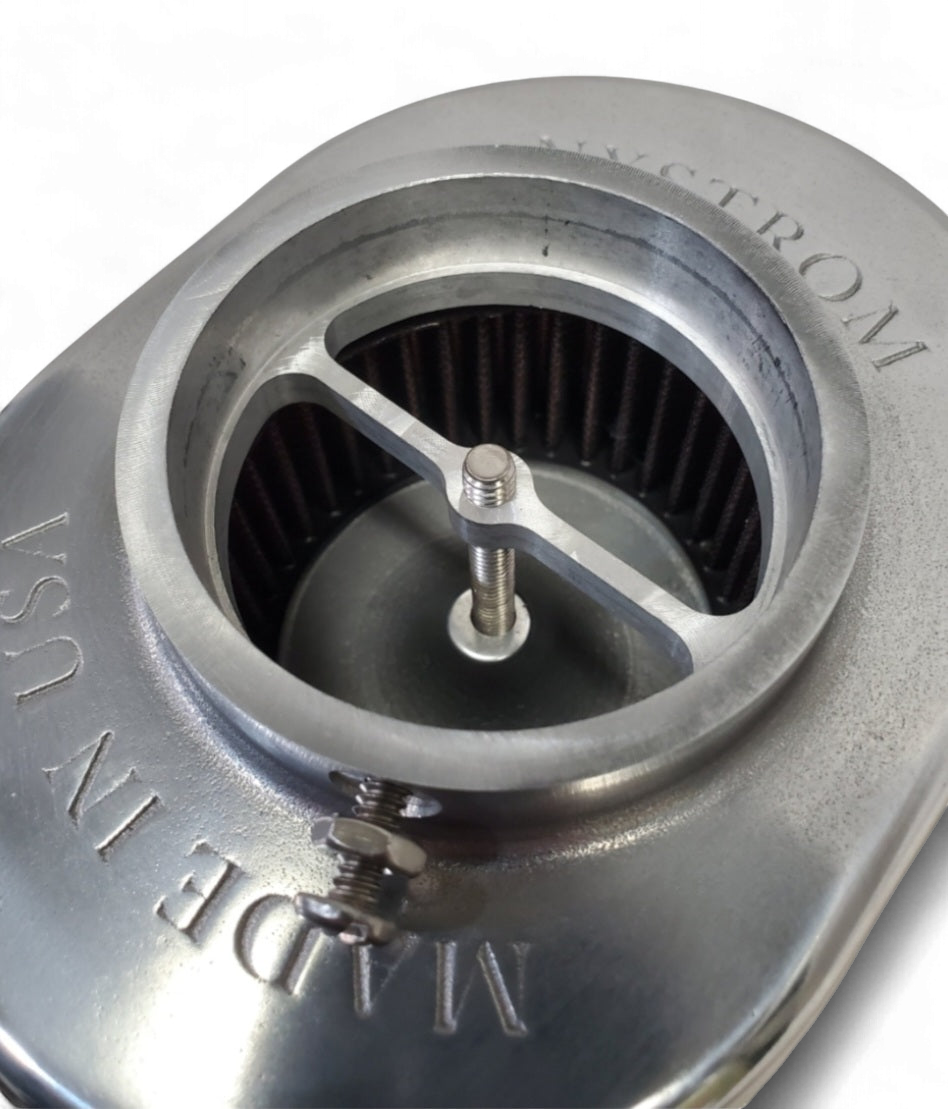 Close-up of Stromberg 97 air cleaner showing internal filter and polished finned top with Made in USA stamping