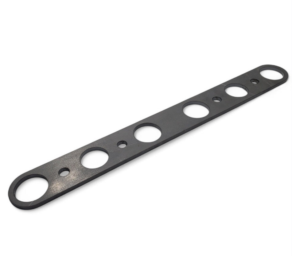 Black metal Model A header flange with multiple circular cutouts along its length